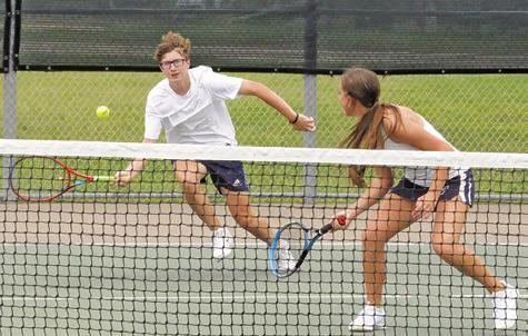 CALDWELL’S CAYDEN ZBORIL runs to return the ball as his mixed doubles teammate Kylie Vogler looks on during their first round match at last week’s Class 4A Region 3 Tennis Tournament in Bryan.