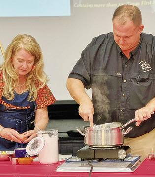 CINDY WILLIAMS, “Texicurean” -- inspired by her passion for Texas food and hospitality, and Brian Broaddus make “Shiny Frosting,” a recipe of Margaret Lea Houston. Williams held a cooking presentation last Tuesday night in honor of the county’s annual Heritage Week.