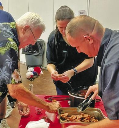 JOE RYCHLIK AND OTHERS attending last Tuesday night’s historic cooking demonstration at the Caldwell Civic Center enjoyed sampling Sam Houston’s barbecue sauce. The demonstration was part of the Burleson County Historical Commission’s annual Heritage Week.