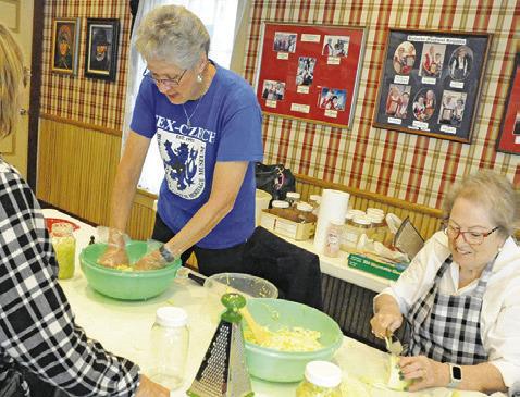 THESE LADIES WITH THE Burleson County Czech Heritage Museum demonstrated making sauerkraut during the museum’s second annual Heritage Day on Saturday. -- Tribune photo by Denise Squier