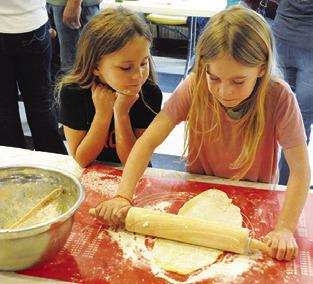 THESE GIRLS are making noodles during Saturday’s Heritage Day at the Burleson County Czech Heritage Museum.