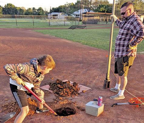 BRENT WILLARD IS assisted at the field by OSR Indies player Ryker Chollett. Many local volunteers worked on the field.