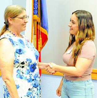DESIREE VENABLE, Democratic Party candidate for Texas House District 17, shakes Burleson County Democratic Party Chair Linda Arbuckle’s hand at last Thursday’s dinner honoring Democratic Party election officials. -- Tribune photo by Denise Squier