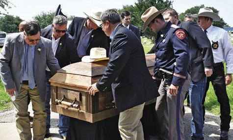 PALLBEARERS CARRY LARRY See’s casket on Tuesday, April 30, at the Caldwell Masonic Cemetery. A large crowd gathered for See’s funeral and burial. See was a longtime Burleson County law officer.