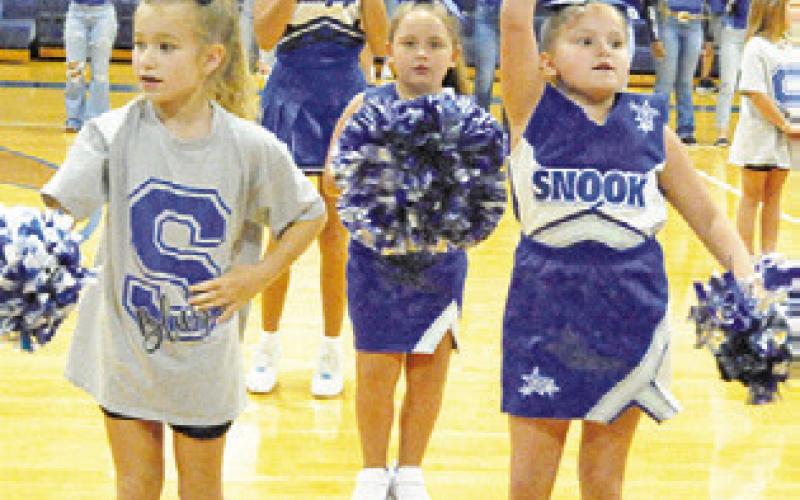 FUTURE BLUEJAY cheerleaders help the current cheerleaders pump up the crowd at last week’s “Meet the Bluejays.”