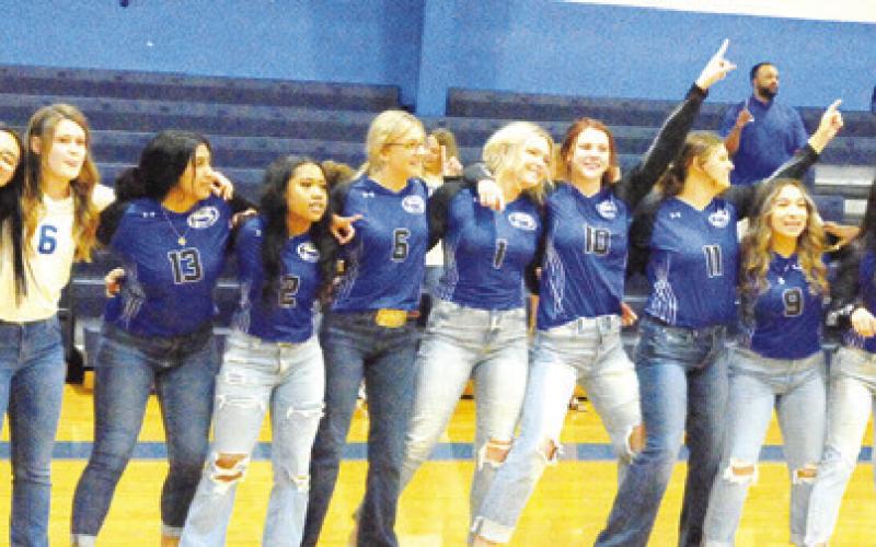 MEMBERS OF THE SNOOK LADY JAYS volleyball teams sing the school song during last Thursday night’s “Meet the Bluejays.” -- Tribune photo by Denise Squier