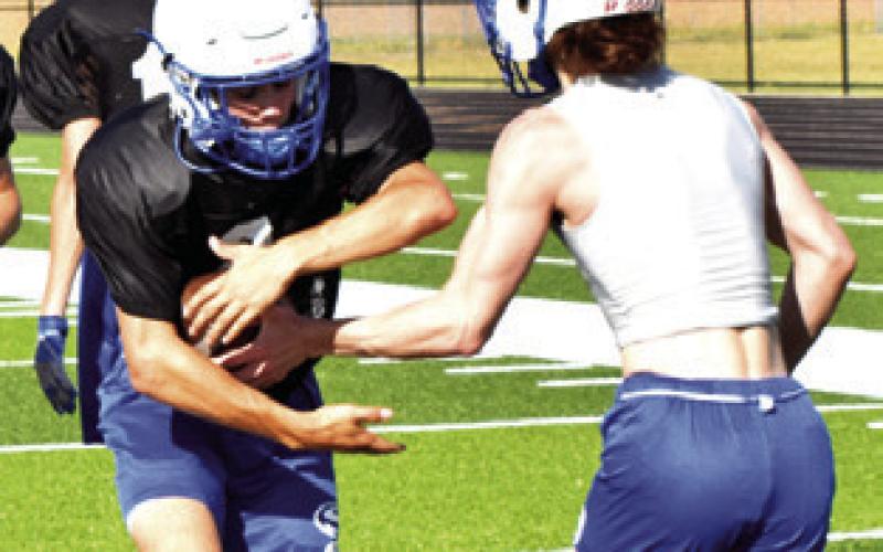 THE SNOOK Bluejays work on handoff skills during the Monday practice.