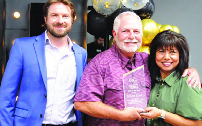 DONNIE COOK, CENTER, was honored as the chamber’s “Man of the Year” during the Burleson County Chamber of Commerce banquet last Thursday. Also pictured is Stu Chapman and Susan Mott. Tribune photo by Denise Squier