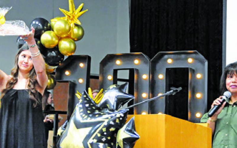 BURLESON COUNTY CHAMBER of Commerce Director Susan Mott acts as auctioneer during a live auction at last week’s chamber banquet at the Caldwell Civic Center. Tribune photo by Denise Squier