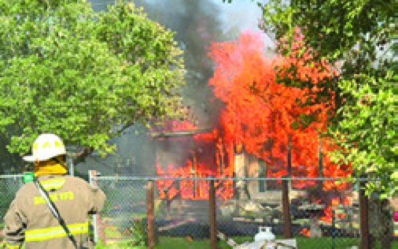 A SNOOK firefighter responds to the scene of this house fire at Shady Oaks Drive at Somerville Place Subdivision. Photo courtesy of Birch Creek VFD.