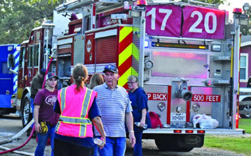 FIREFIGHTERS RESPOND TO this fire on Friday, July 24, on Shady Oaks Drive at Somerville Place Subdivision off Park Road 4. Tribune photo by Roy Sanders