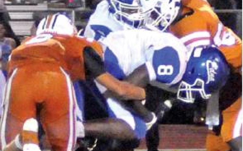 LOGAN KNESEK AND Nicholas Johnson make a tackle last Friday against Edna. The Hornets lost their opener 29-16 at home and will face Rockdale this week.