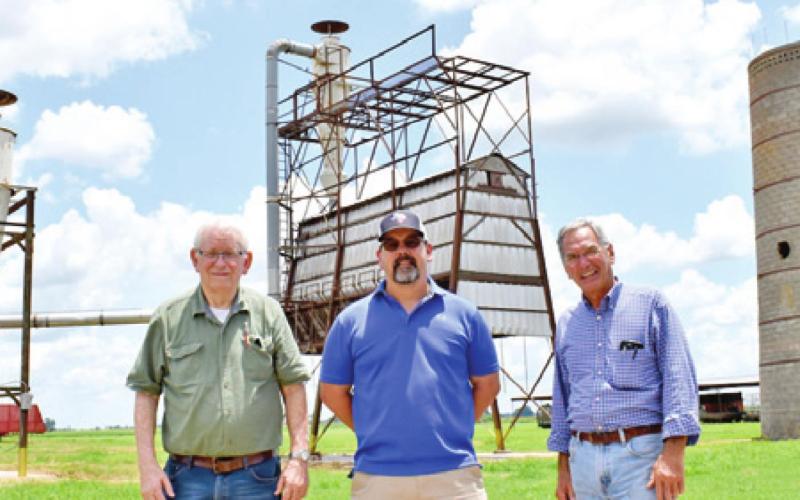 LEIGHTON STOVALL stands with Paul Silas, left, and Vince Patranella, right, at the gin.