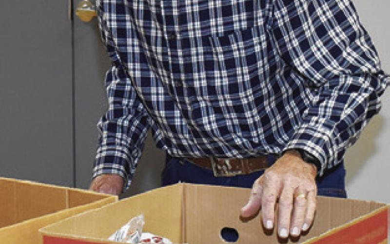 MARK HARRIS works at the Food for Families Food Drive last Wednesday, Dec. 4, at St. Mary’s Catholic Church in Caldwell.