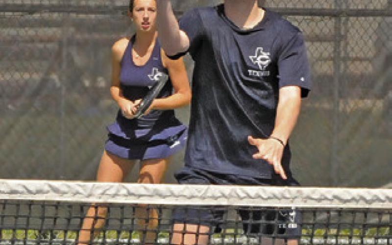 CADEN ZBORIL volleys at the net during mixed doubles match at last week’s Caldwell Classic Varsity Tennis Tournament. Tribune photo by Denise Squier