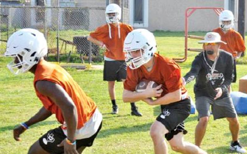 CALDWELL HIGH SCHOOL Assistant Coach Kyle Toney watches as the Caldwell Hornets work out for the first time on Monday, Aug. 5, at the high school. -- Tribune photo by Roy Sanders