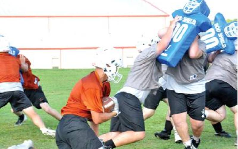 THE CALDWELL HORNETS work on their offensive plays for the first time in a Monday morning, Aug. 5, workout at the high school. Monday was the first day of fall practice. -- Tribune photo by Roy Sanders