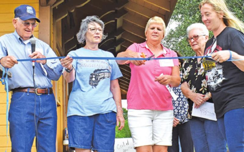 DEANVILLE HERITAGE FOUNDATION members cut a ribbon to open the Deanville Depot Museum. -- Tribune photo by Roy Sanders