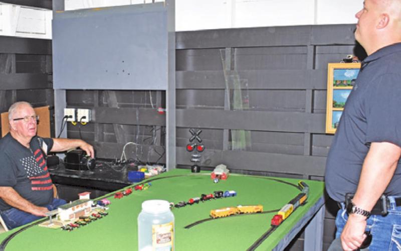 PEOPLE ATTENDING last Saturday’s Deanville Depot Museum opening enjoyed seeing the miniature trains inside the museum.