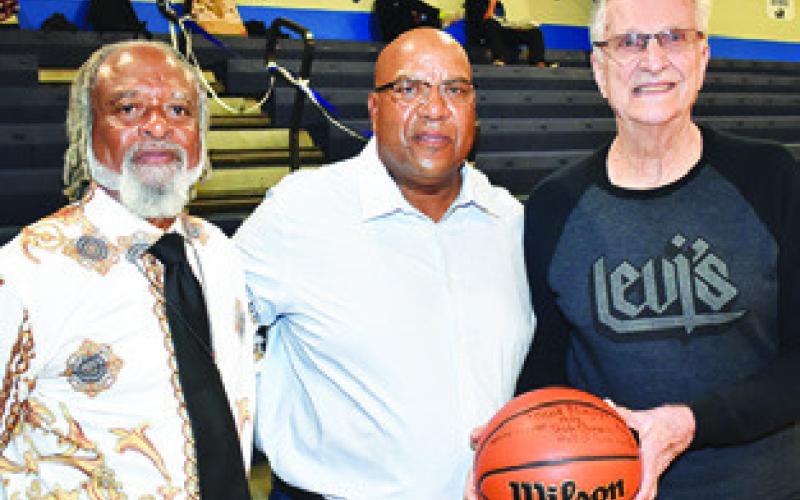 FORMER SNOOK Coach Jimmy Horn talks to Bluejays players from the early 1980s, Terrance Cole and Wesley Jackson.