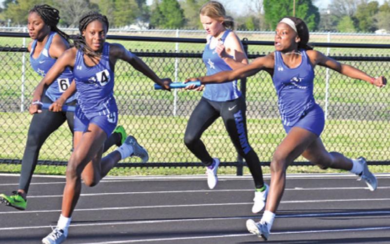 THE LOUIS SISTERS, Bre’Asia and Bre’Anna, compete in a girls’ relay race at the Bluejay Relays last week. -- Tribune photo by Roy Sanders