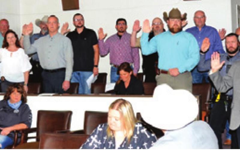 BURLESON COUNTY SHERIFF’S DEPUTIES are sworn into office by County Clerk Anna Schielack on Sunday at the county courthouse. -- Tribune photo by Roy Sanders