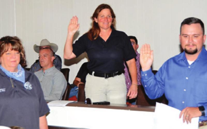 RESERVE OFFICERS ZETA Fail, Elizabeth Morris and Mark Koch are sworn into office on Sunday, March 15, by Burleson County Clerk Anna Schielack. -- Tribune photo by Roy Sanders