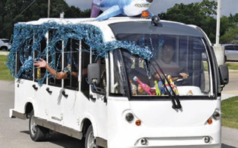 THIS WELL DECORATED bus is part of the Saturday morning parade in Somerville during the Crater Motorcycle Rally.