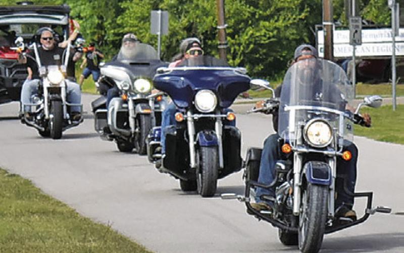 BILERS RIDE ALONG Eighth Street on Saturday morning, May 16, as part of the Crater Motorcycle Rally held at Welch Park at Lake Somerville. The rally was again well attended.