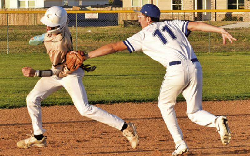 ALBERTO NORWOOD OF Snook tags this Bellville Faith Academy base runner on Friday in Snook. The Bluejays lost 12-1. Tribune photo by Roy Sanders