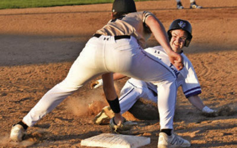 GABE LACAZE OF Snook slides into third base last Friday against Bellville Faith Academy in Snook. The Bluejays lost 12-1. Tribune photo by Roy Sanders