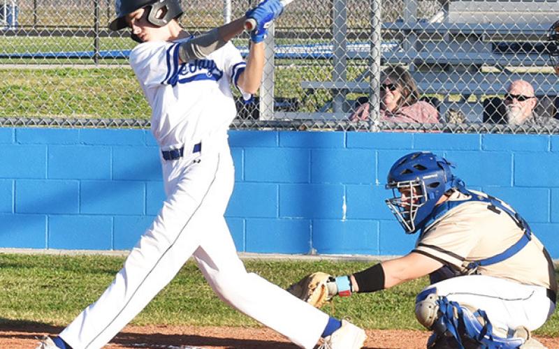 BLAKE BIMMERLE SWINGS at this pitch on Friday against Bellville Faith Academy in Snook. The Bluejays lost 12-1. Tribune photo by Roy Sanders