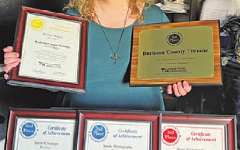 TRIBUNE EDITOR DENISE Squier is pictured with the awards presented to the newspaper by the Texas Press Association on Saturday during its annual convention over July 28-30 in San Marcos.