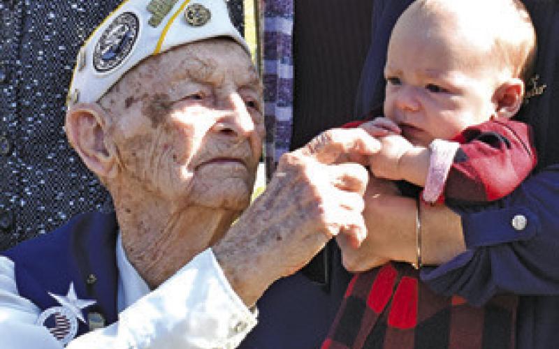 HORACE HAMILTON says hello to baby Everett, great-grandson of Pearl Harbor veteran Albert Block, at a 2021 ceremony at the George Bush Presidential Library.
