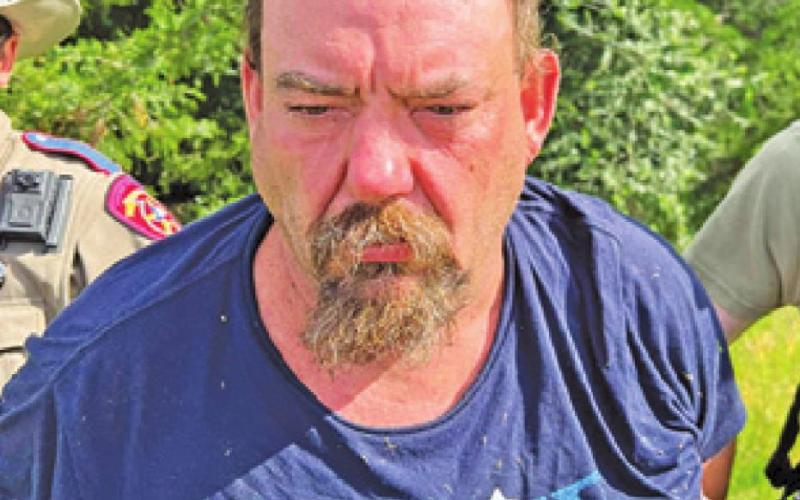 TODD WANGLER IS placed under arrest following the manhunt in the Chriesman area.