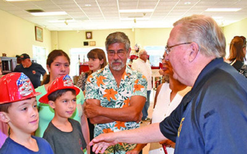 CALDWELL FIRE CHIEF Harry Bowers greets visitors on July 22 at the fire station during the 140th anniversary celebration. Tribune photo by Roy Sanders
