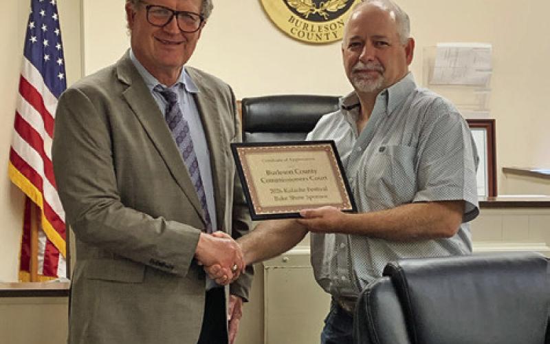 BRUNO SHIMEK PRESENTS County Judge Keith Schroeder with a certificate recognizing the commissioners court as a sponsor of the Kolache Festival Bake Show. Photo courtesy of Holly Narro