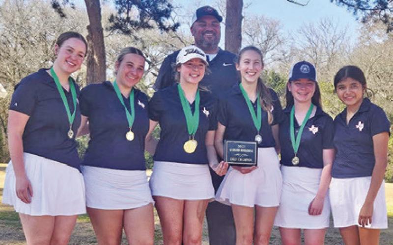 THE CALDWELL LADY Hornets display their trophy. They include, from left, Alison Krueger, Tanzley Johnson, Raeleigh Ussery, Coach Marcus Escalante, Madilyn Schneider, Brandy Gillar and Patsy Pineda.
