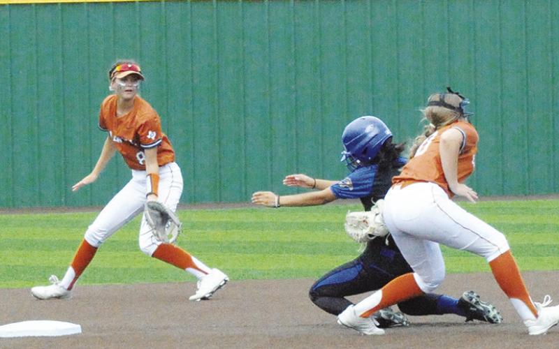A WASHINGTON RUNNER is tagged out by Kelly Urbanovsky during the Caldwell-Washington bidistrict game last Friday in Navasota. Also pictured is Jillian Vykukal. -- Tribune photo by Denise Squier