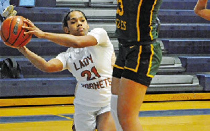 AVELYNN O’RILEY looks to pass the ball during the Caldwell-Lexington game at the Snook Lady Jays Basketball Tournament.