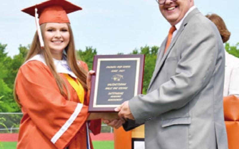 HALLE KOCIAN receives her valedictorian plaque by CISD Superintendent Andrew Peters.
