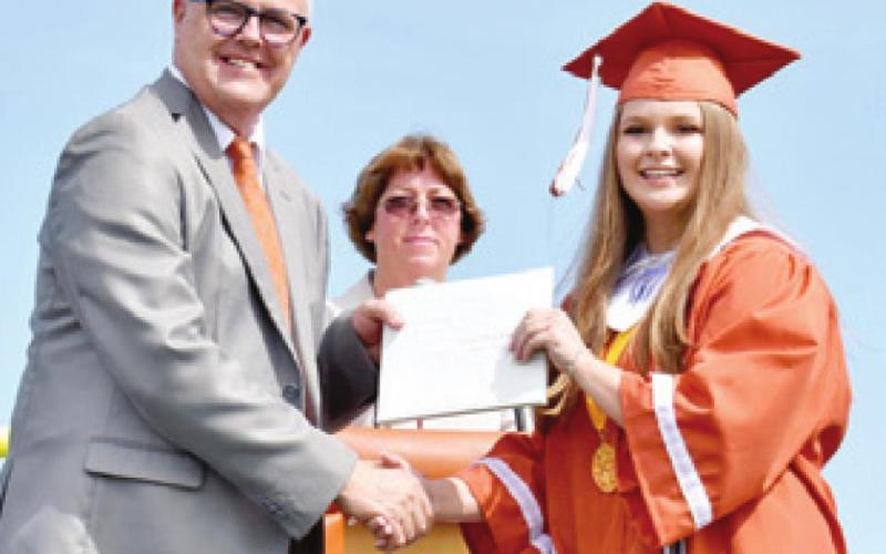 HALLE KOCIAN receives her diploma by CISD Superintendent Andrew Peters.