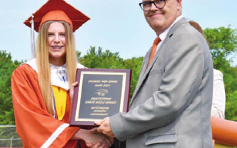 CAYLEE HERMES receives her salutatorian plaque by CISD Superintendent Andrew Peters.