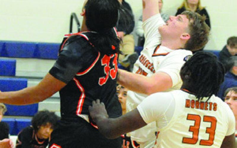 MATTHEW BAASEN fights for the ball. Also pictured is Jegorean Hewitt. Tribune photo by Denise Squier