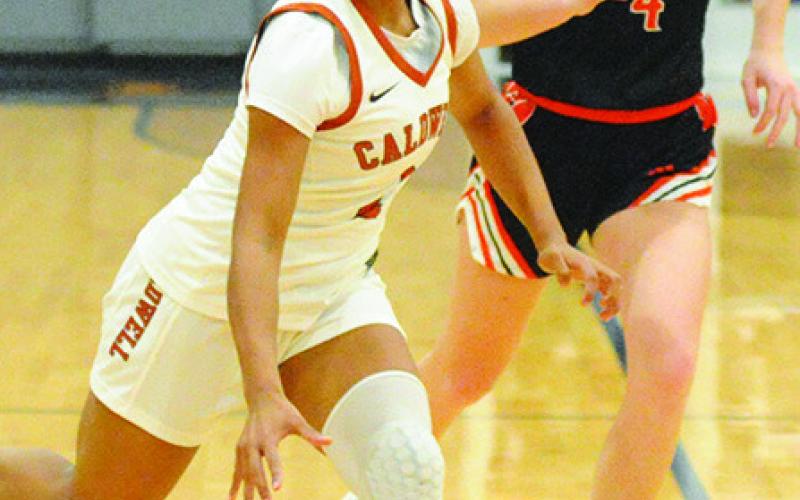 AVELYNN O’RILEY dribbles down the court during the Caldwell-Smithvile game on Friday. Tribune photo by Denise Squier