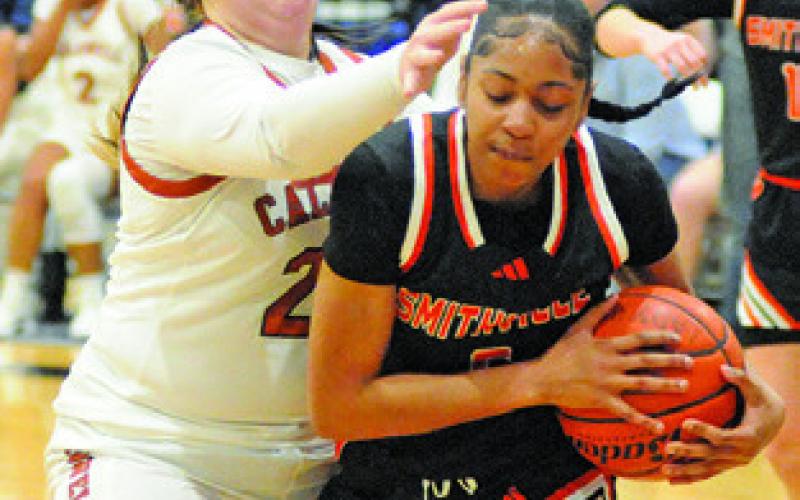 HANNAH RAE CLARK attempts to strip the ball from a Smithville player during the Caldwell-Smithville game last Friday at Hornet Gym. Tribune photo by Denise Squier
