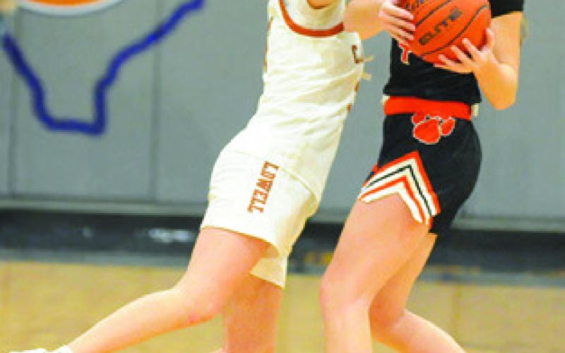 MAYZI WITHERWAX defends the pass during the Caldwell-Smithville game on Friday night. Tribune photo by Denise Squier