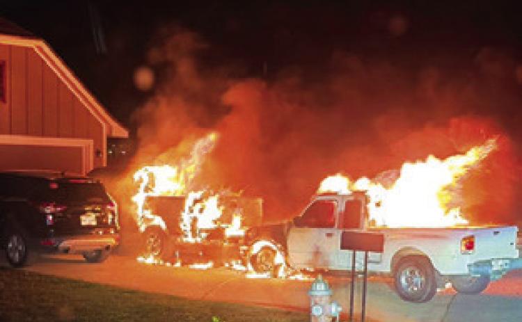 FIRE ENGULFS THESE pickups on Meadow Brook Drive.