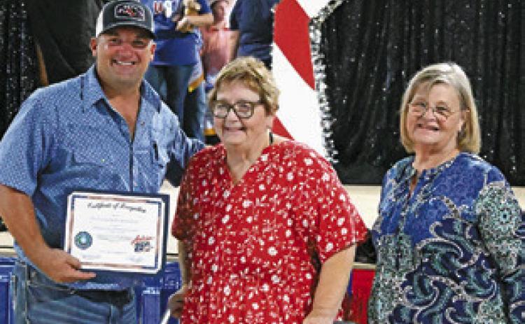 MELYNDA GIESENSCHLAG and Gayla Townsend with the Burleson County Historical Commission recognized the Burleson County Fair Association on Sunday prior to the Baked Goods auction for the 2026 fair’s theme celebrating the United States’ 250th birthday. Tribune photo by Denise Squier