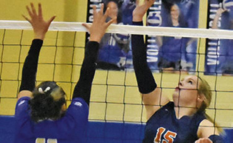 ADDISON HOLCOMB reaches to push the ball past a Rockdale blocker during Caldwell’s road win over the Lady Tigers on Friday. Tribune photo by Roy Sanders